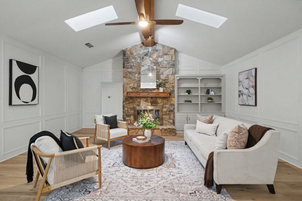 Vaulted living room staged around a dramatic stone fireplace