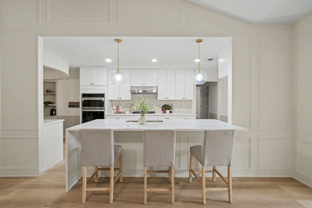 Bright white kitchen staged with soft neutral counter stools