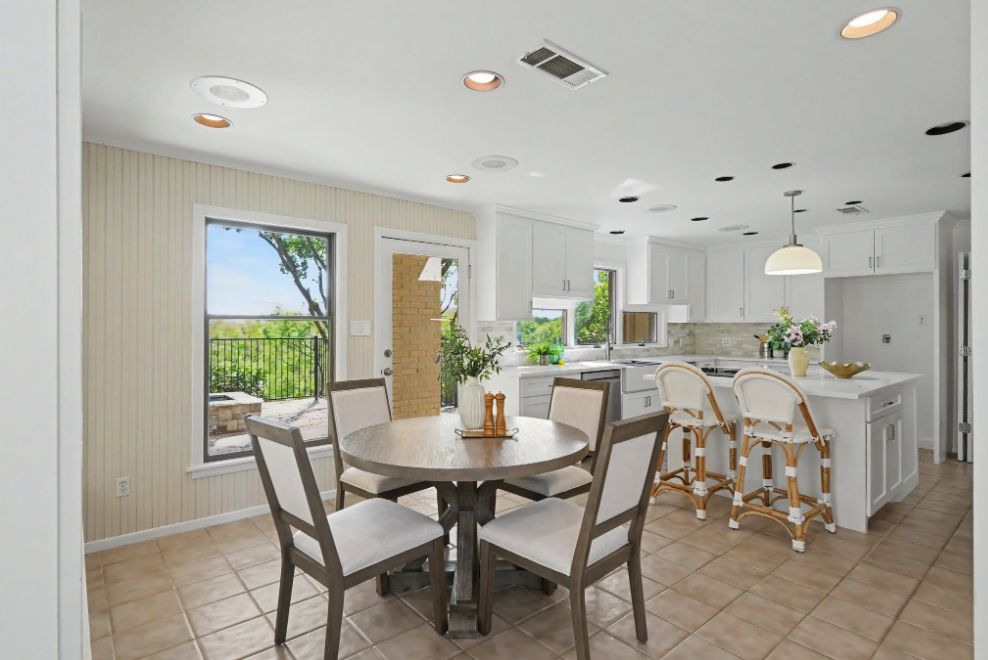 Breakfast area and white kitchen staged in soft neutral tones