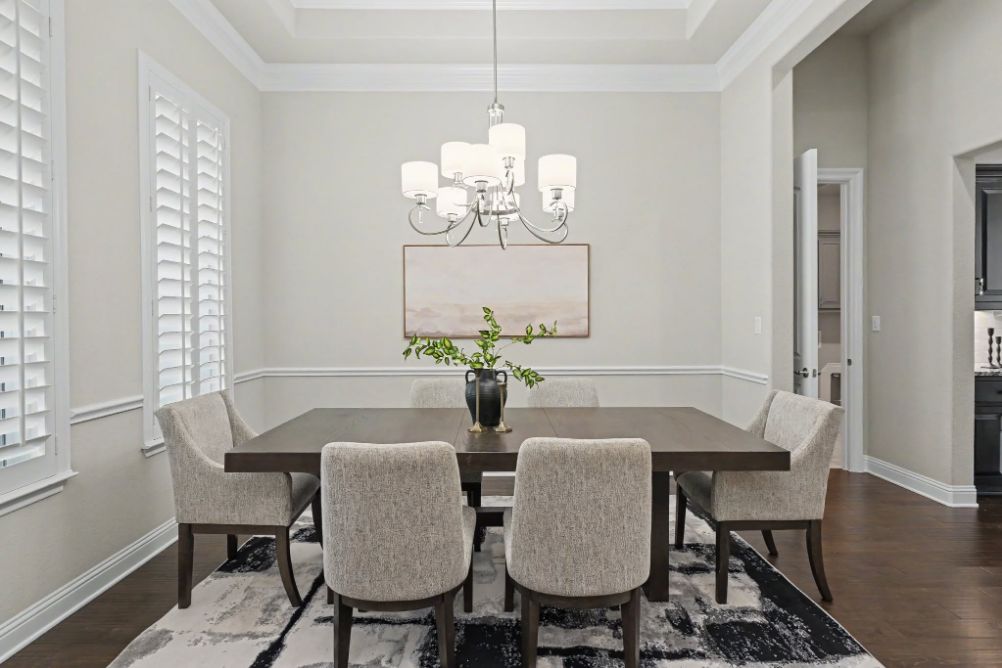 Staged dining room with neutral upholstered chairs
