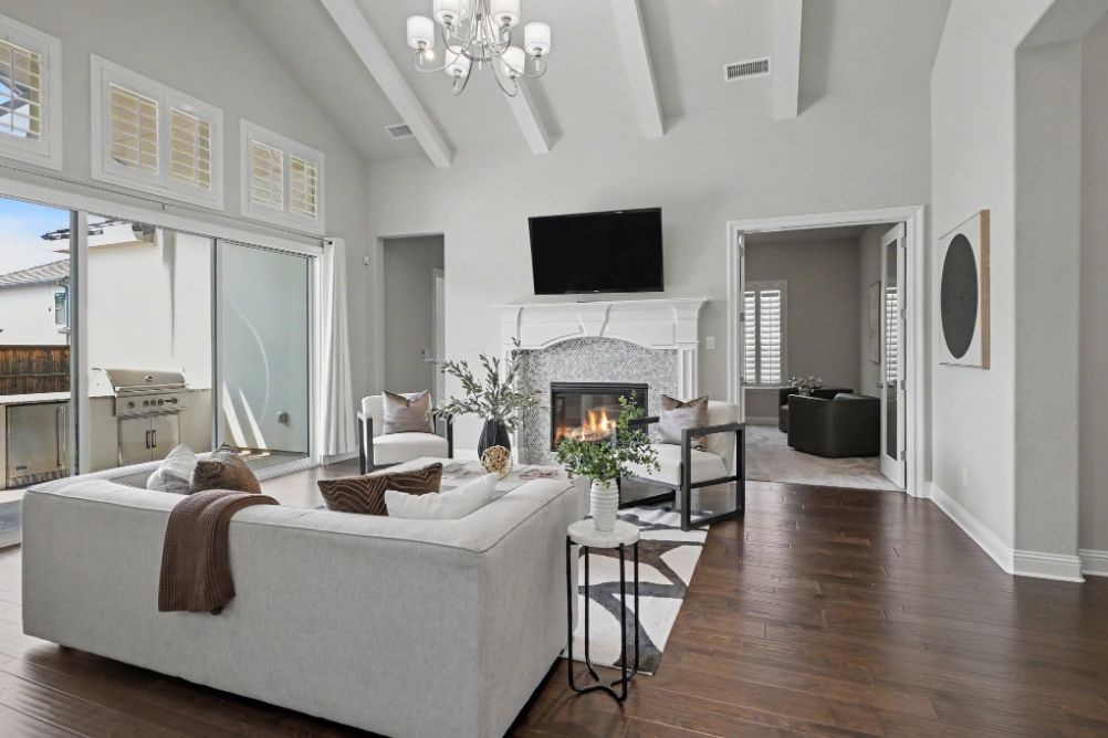 Staged family room with fireplace and patio view