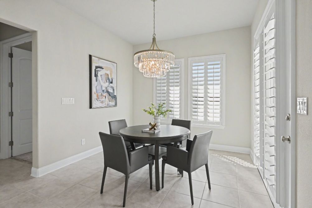 Breakfast room with round dining table and chandelier