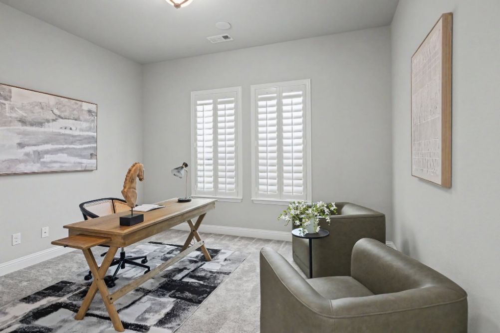 Staged home office with desk and two lounge chairs