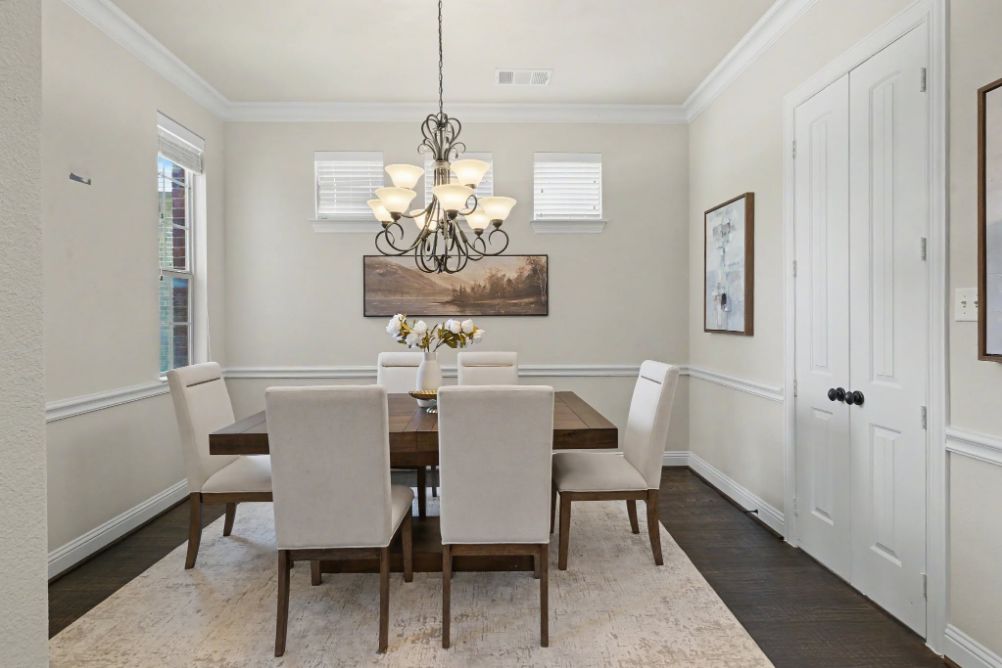 Formal dining room staged with six upholstered chairs