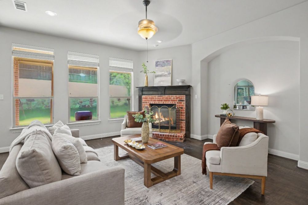 Living room conversation area arranged around a brick fireplace