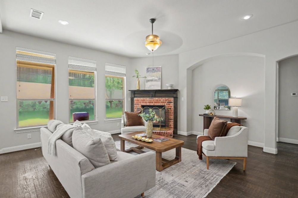 Staged living room in a soft neutral palette with warm brown accents